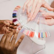 a client choosing on a nail color palette