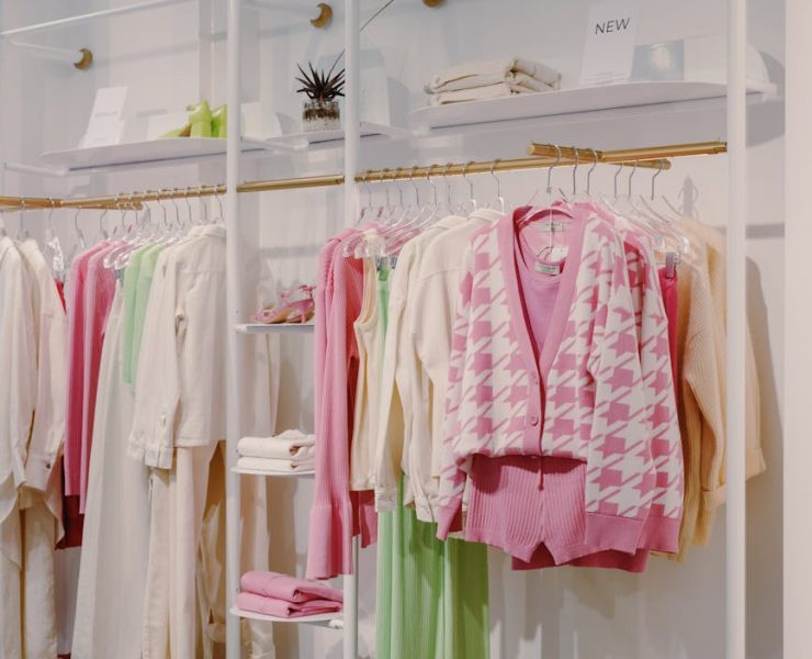 pink and white long sleeve shirt hanging on gold and white clothing rack
