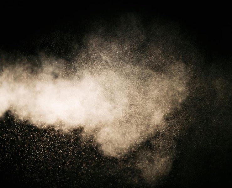 white dust particles on black background